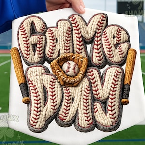 May include: A white baseball-themed sign with the words "Game Day" in a knitted style. The letters are white with red stitching, and the image includes a baseball, glove, and two bats. The background is a green field.