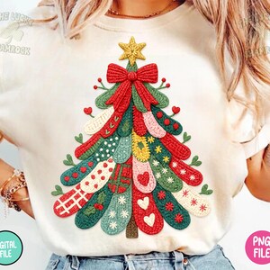 May include: Cream-colored t-shirt featuring a colorful Christmas tree design. The tree is composed of various textured elements in red, green, yellow, and white, with a red bow and a gold star on top. The words "DIGITAL FILE" and "PNG FILE" are printed on the shirt.