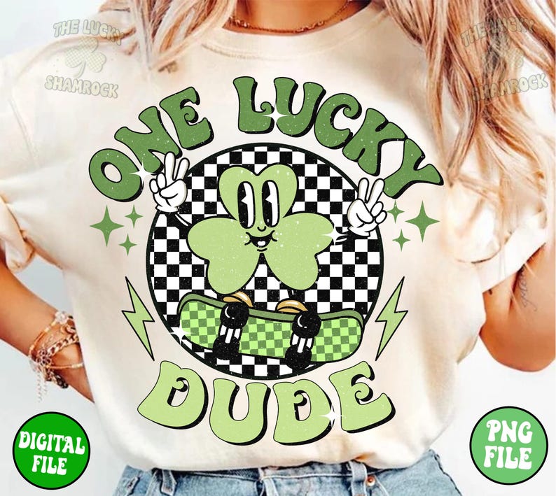 May include: A white t-shirt with a green shamrock graphic. The shamrock is wearing a checkered hat and holding a skateboard. The text "One Lucky Dude" is written in green letters around the shamrock.