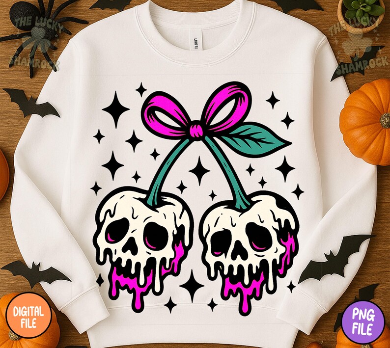 May include: White sweatshirt featuring a graphic of two cherries with skull faces, dripping pink 'juice', and a pink bow. The design includes black star accents. A unique and spooky design for Halloween.
