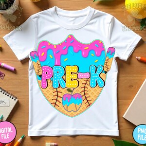 May include: White t-shirt with a colorful graphic design for Pre-K. The design features a donut with pink frosting and blue sprinkles, a baseball, and pencils. The word "PRE-K" is in large, colorful letters.