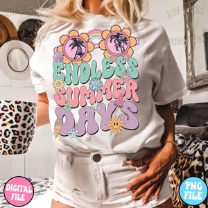 May include: White t-shirt with a graphic design featuring a pair of sunglasses with palm trees, a rainbow, and the text "Endless Summer Days" in a retro font. The graphic also includes various other summer-themed elements like ice cream, a watermelon, a peace sign, and flowers.