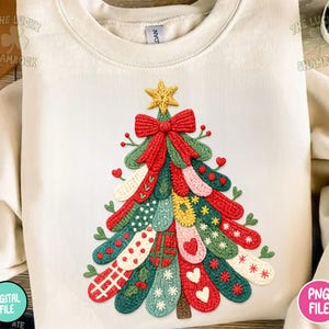 May include: Cream-colored sweatshirt featuring a colorful Christmas tree design. The tree is made of various patterned elements in red, green, yellow, and white, topped with a gold star and a red bow. The Lucky Shamrock and PNG File logos are visible.