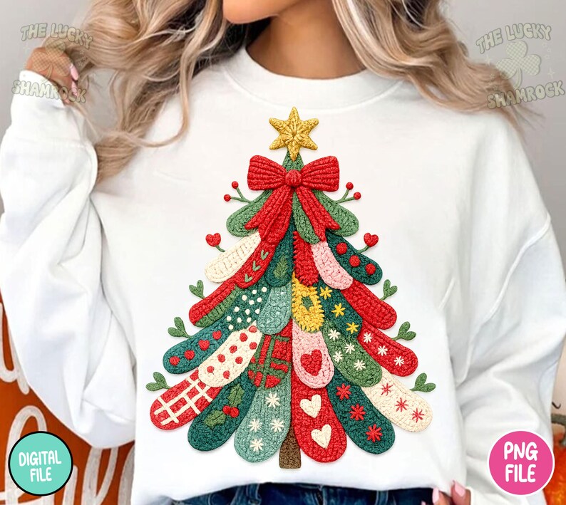 May include: White sweatshirt featuring a colorful Christmas tree design. The tree is composed of various patterned elements in red, green, and other colors, topped with a gold star and a red bow. The design has a textured, stitched appearance.