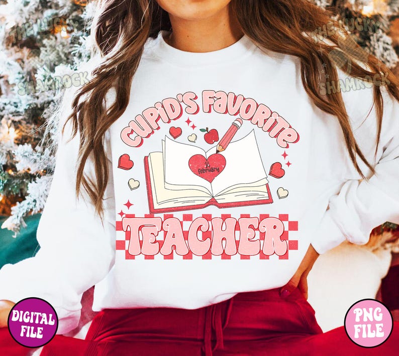 May include: White sweatshirt with a pink and red graphic design that says "Cupid's Favorite Teacher" with a heart, a book, and a pencil.