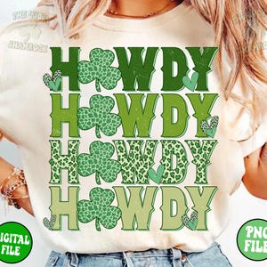 May include: A white t-shirt with the text "Howdy" repeated four times in green, yellow, and brown. Each "Howdy" is decorated with a shamrock design.