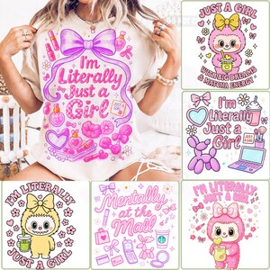 May include: A collection of graphic t-shirts with the phrase "I'm Literally Just a Girl" and other related designs. The shirts feature pink and purple illustrations of makeup, bows, and cute characters. The overall theme is girly and fun.