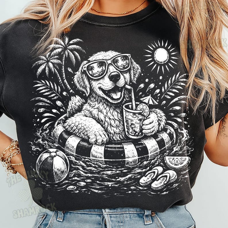 May include: Black graphic t-shirt featuring a dog wearing sunglasses and floating in a pool on an inner tube. The dog is holding a drink with a straw. Palm trees, a sun, and beach accessories complete the summer scene.