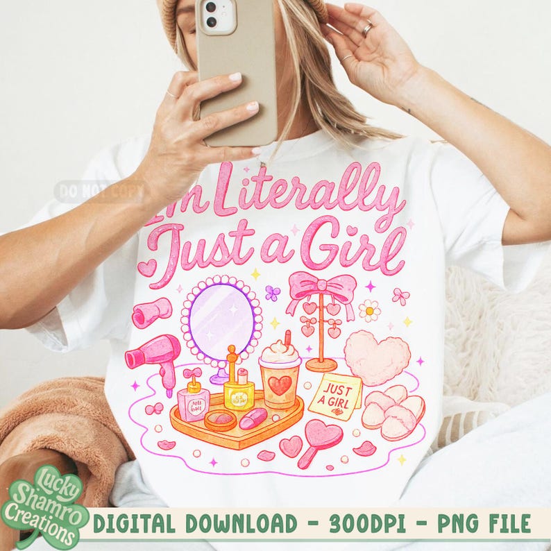 May include: White t-shirt with the text "I'm Literally Just a Girl" in pink. The design includes illustrations of makeup, a mirror, a hair dryer, and a heart-shaped pillow. The shirt is a digital download.