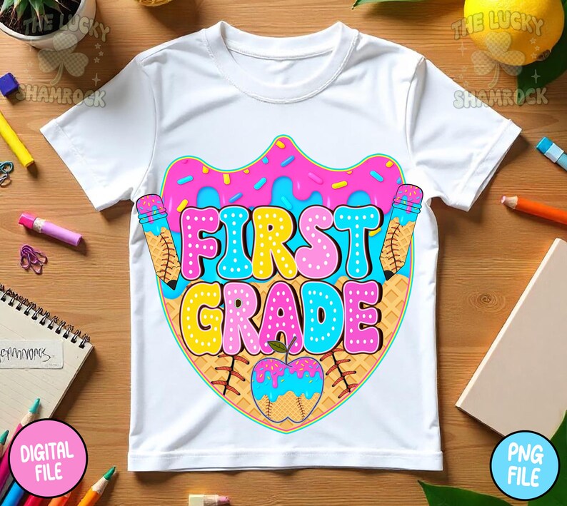 May include: White t-shirt with a colorful graphic design for first grade. The design features the words "FIRST GRADE" in bubble letters, a pink donut, ice cream cones, and a baseball-shaped apple.