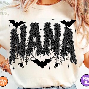 May include: Cream-colored t-shirt with a black and gray leopard print "NANA" design. The design includes bats, spiderwebs, spiders, and stars, creating a Halloween theme. The shirt also has a "DIGITAL FILE" and "PNG FILE" label.