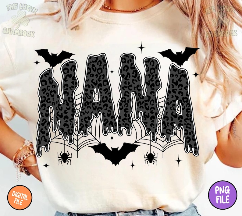 May include: Cream-colored t-shirt with a black and gray leopard print "NANA" design. The design includes bats, spiderwebs, spiders, and stars, creating a Halloween theme. The shirt also has a "DIGITAL FILE" and "PNG FILE" label.