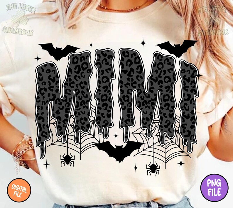 May include: Cream-colored t-shirt featuring the word "MIMI" in a dripping, leopard-print design. The design includes bats, spiderwebs, spiders, and stars, creating a Halloween theme. The shirt also has a "DIGITAL FILE" and "PNG FILE" label.