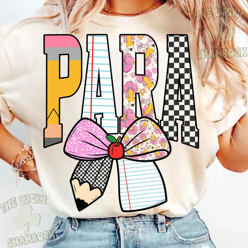 May include: Cream-coloured t-shirt featuring the word "PARA" in a vibrant design. The letter "P" is a pencil, "A" is lined paper, "R" is a floral pattern, and the last "A" is a black and white checkerboard. A bow with a pencil and lined paper design is at the bottom.
