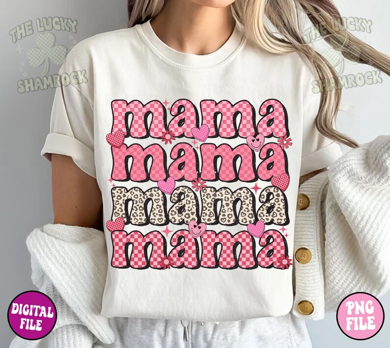 May include: A white t-shirt with the text "mama mama mama mama" in pink and black letters with different patterns. The letters are in a retro style with hearts, flowers, and smiley faces.