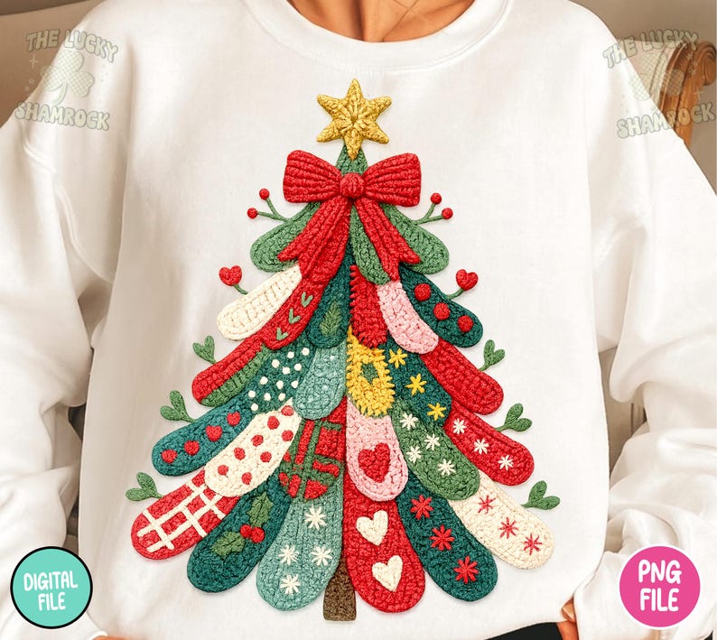May include: White sweatshirt featuring a colorful, textured Christmas tree design. The tree is adorned with various patterns and embellishments, including a red bow, a gold star, and decorative elements. The design is made of various colors, including red, green, and yellow.