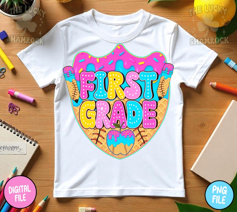 May include: White t-shirt featuring a colorful graphic design for first grade. The design includes the words "FIRST GRADE" in bubble letters, a donut, a baseball, and pencils. The shirt is made of a soft, comfortable material.
