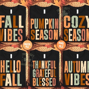 May include: Black t-shirts with fall-themed text designs. The shirts feature phrases like "Fall Vibes," "Pumpkin Season," and "Cozy Season" in orange, brown, and green distressed fonts. The shirts are displayed on a woven background.