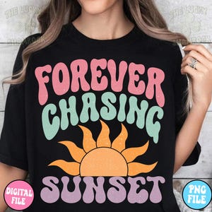 May include: A black t-shirt with the text "FOREVER CHASING SUNSET" in a retro, colorful font. The text is layered over a stylized orange sun with rays.