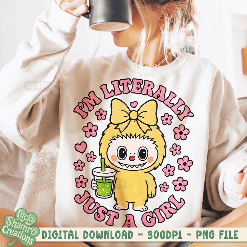 May include: Cream-colored sweatshirt with a cartoon graphic of a yellow creature holding a green drink, surrounded by pink flowers and the text "I'M LITERALLY JUST A GIRL". The design includes a yellow bow and a heart.