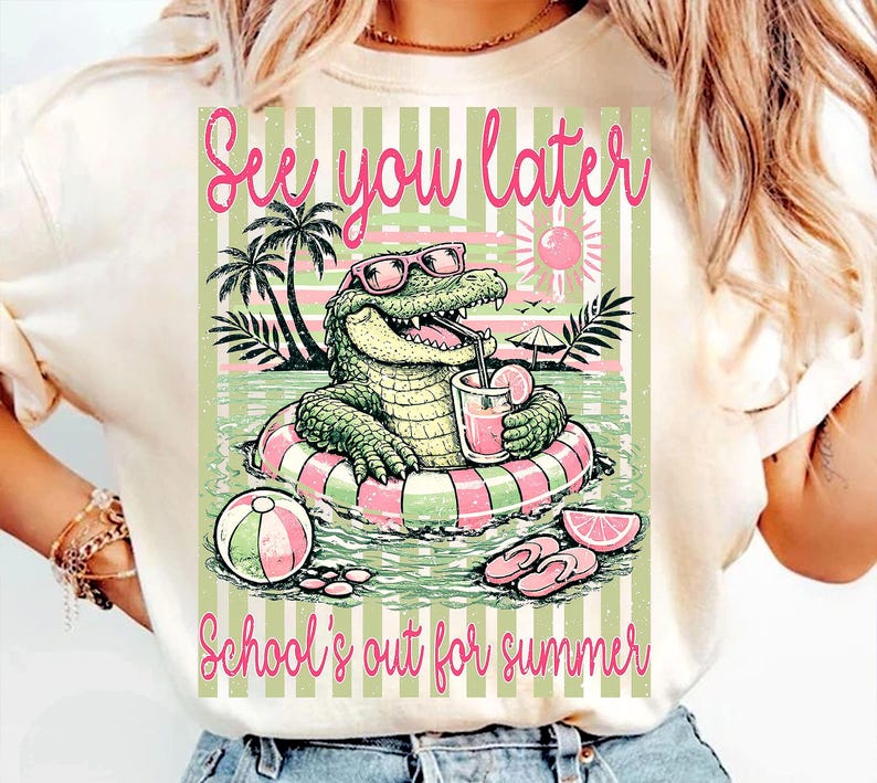 May include: A cream-coloured t-shirt with a cartoon alligator wearing sunglasses and floating in a pool on an inflatable ring. The text "See you later" and "School's out for summer" are displayed in pink script.