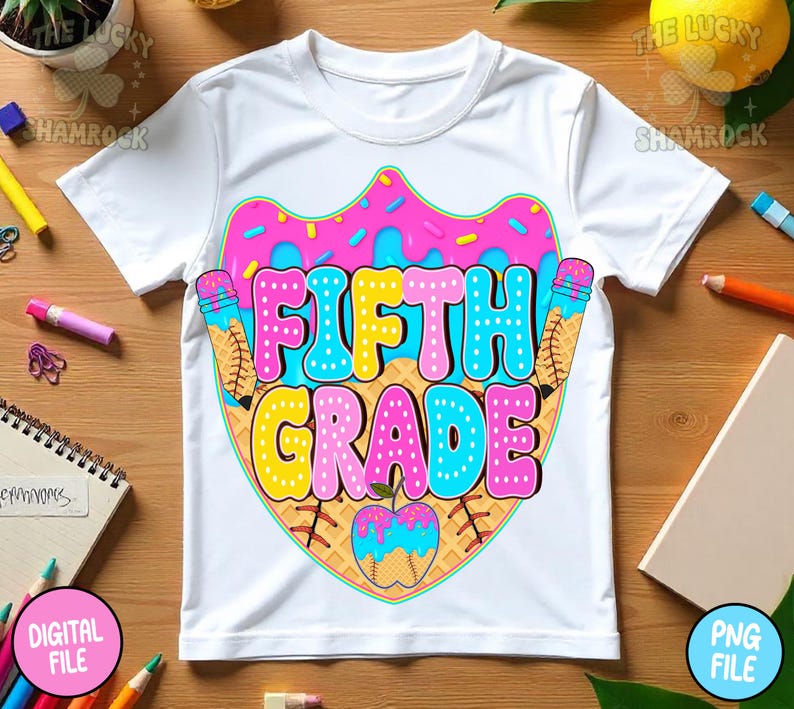 May include: White t-shirt with a colorful graphic design. The design features the words "FIFTH GRADE" in bubble letters, surrounded by ice cream cones and a baseball-themed apple. The design is in pink, blue, yellow, and brown.