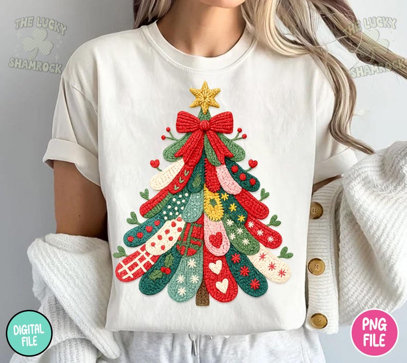 May include: Cream-colored t-shirt featuring a colorful Christmas tree design. The tree is composed of various patterned elements in red, green, yellow, and white, topped with a gold star and a red bow. The text "THE LUCKY SHAMROCK" is visible.