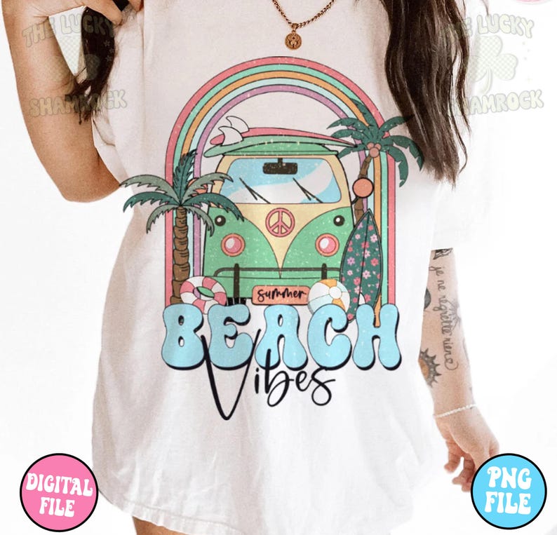 May include: A white t-shirt with a graphic design of a green vintage van with a surfboard on top, palm trees, and a rainbow. The text "Summer" and "Beach Vibes" is printed on the shirt.
