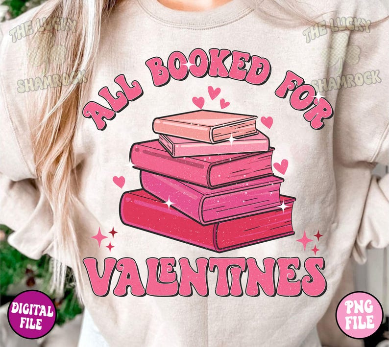 May include: A pink and white graphic design on a light beige t-shirt. The design features a stack of books with hearts and the text "All Booked For Valentines".