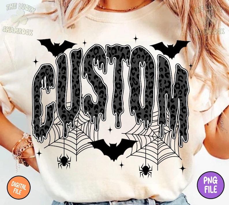May include: Cream-colored t-shirt featuring the word "CUSTOM" in a dripping, leopard-print design. Includes bats, spiderwebs, spiders, and stars, creating a Halloween theme. The shirt also has the words "DIGITAL FILE" and "PNG FILE" on the bottom corners.