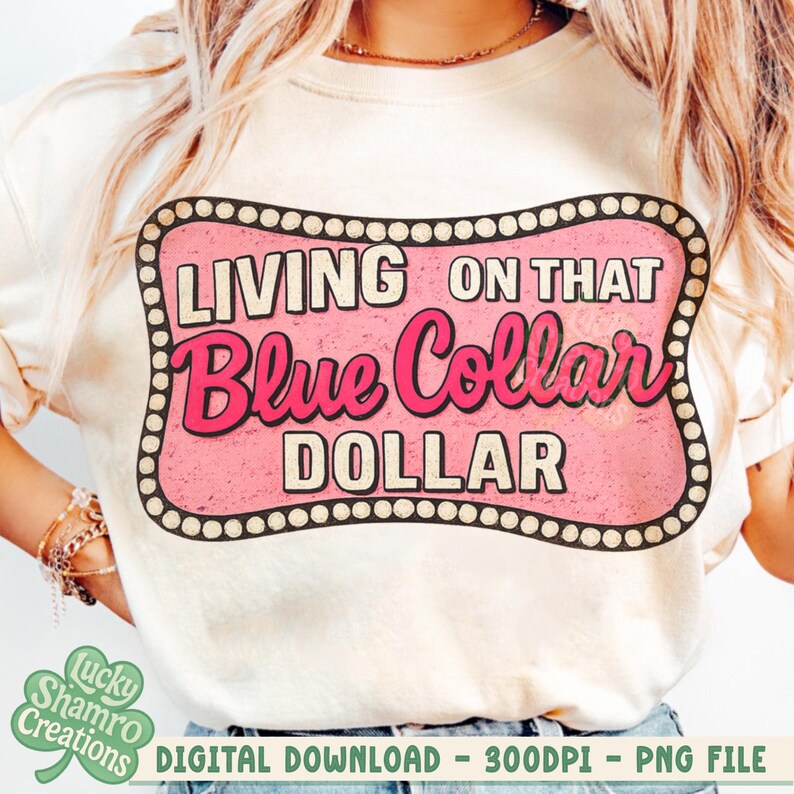 May include: Cream-colored t-shirt featuring a pink and brown graphic that reads "LIVING ON THAT Blue Collar DOLLAR." The design is in a retro style with a decorative border. The shirt is a digital download.