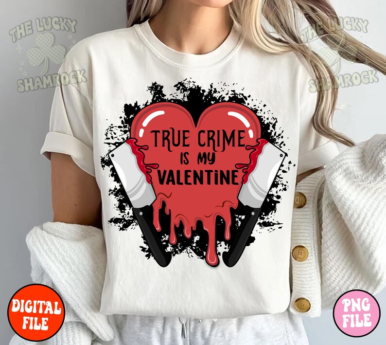 May include: White t-shirt with a red heart graphic that says "True Crime is my Valentine". The heart is dripping with red and has two black knives on either side.