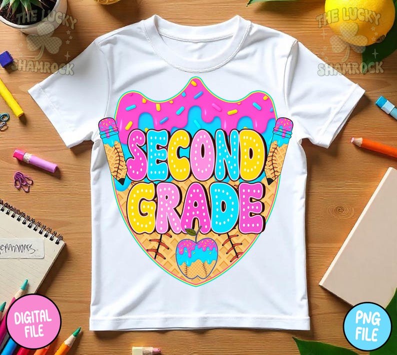 May include: White t-shirt with a colorful graphic design for second grade. The design features the words "SECOND GRADE" in bubble letters, with a donut and ice cream cone theme. The shirt is made of a soft, comfortable material.