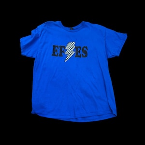 May include: A royal blue t-shirt with a black and white checkered lightning bolt graphic and the text "EFES" printed on the front.