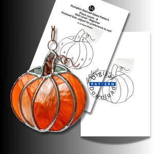 May include: A stained glass pumpkin suncatcher with orange glass segments and a dark stem, accompanied by a printed pattern sheet labeled Pumpkin Stained Glass Pattern, Piece count - 8, Skill Level - Beginner, and Digital Pattern Download.