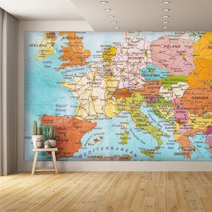 May include: A colorful vintage map of Europe with country borders and major cities labeled. The map is printed on a light blue background with brown lines representing roads and highways.