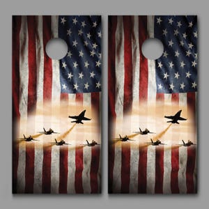 May include: A pair of cornhole boards with a distressed American flag design and a silhouette of fighter jets flying in formation.