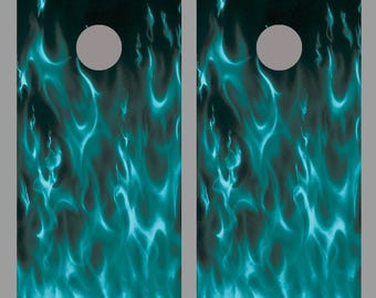 May include: Two teal blue flame designs on a black background. The flames are abstract and have a flowing, organic shape. The designs are meant to be used as a template for a set of cornhole boards.