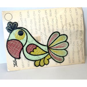 May include: A green, yellow, and pink embroidered iron-on patch of a parrot with the text "Sew-Right-On" repeated around the border.