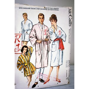 May include: Vintage McCall's sewing pattern for a robe with a printed pattern and transfer. The pattern includes three different styles of robes, one with red and white stripes, one with a white background, and one with a yellow and brown striped pattern. The pattern is labeled "McCall's Printed Pattern with Transfer".