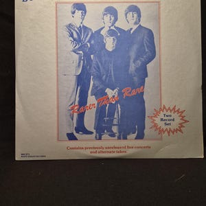 May include: A square vinyl record album cover titled The Beatles Rarer Than Rare. The cover features a blue-toned photograph of the four band members, with the text Two Record Set in a red starburst and the label White Knight Records WK 271.