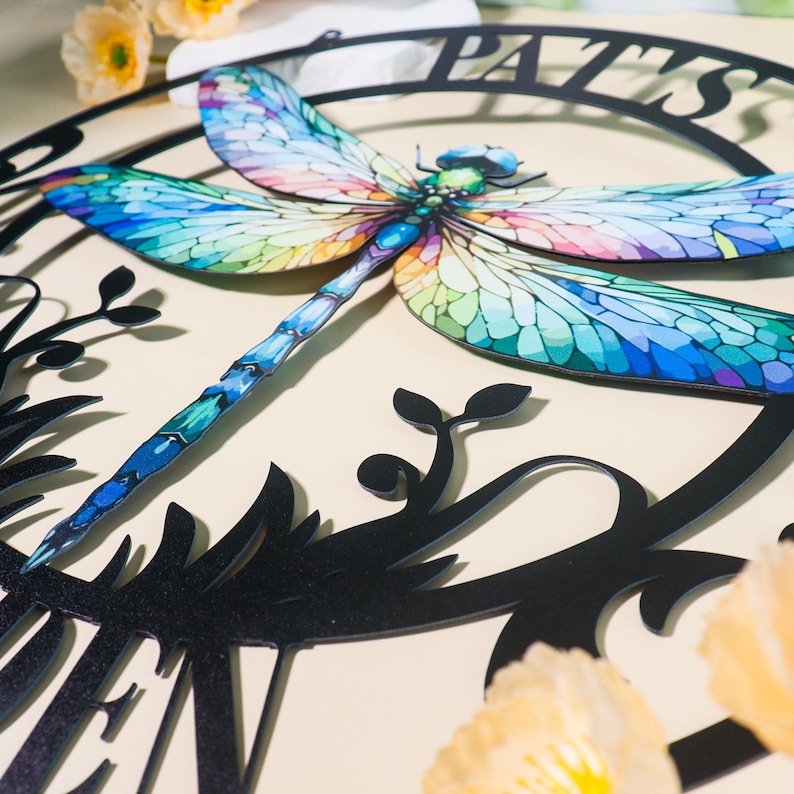 May include: Black metal garden sign with a colorful dragonfly design and the text "Pat's Garden".