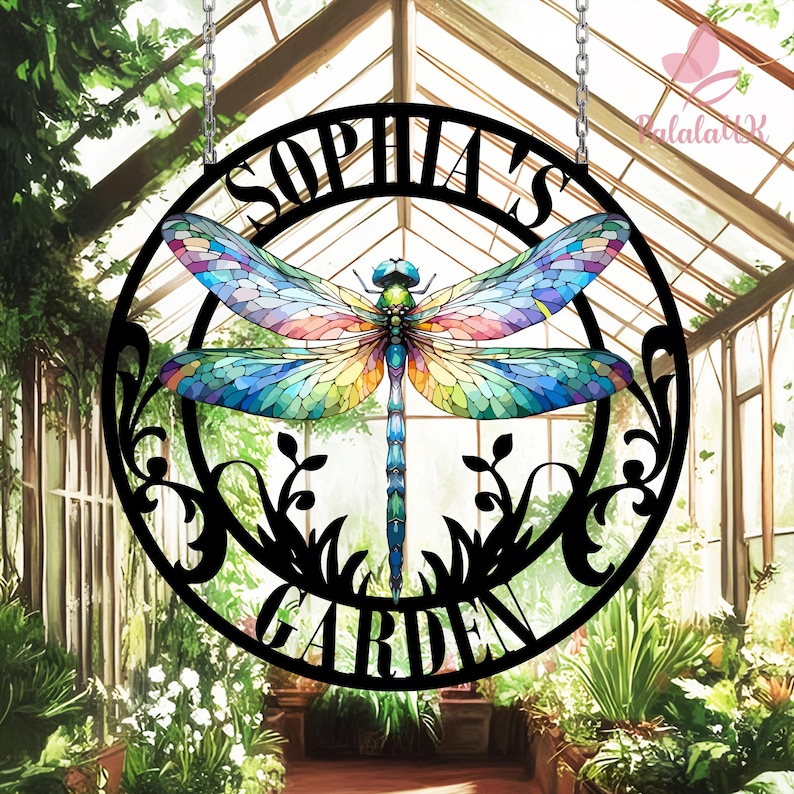 May include: Black metal garden sign with a dragonfly design and the text "Sophia's Garden". The dragonfly has stained glass-like wings with blue, green, yellow, and red colors.