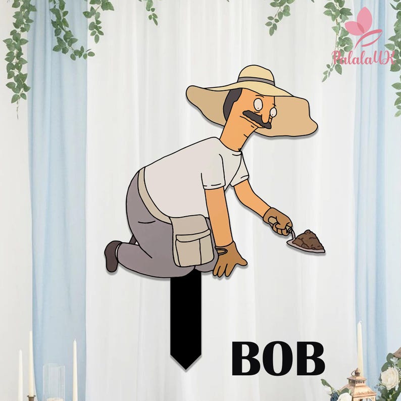 May include: A garden stake featuring a cartoon character wearing a tan wide-brimmed hat, a white t-shirt, and gray pants, kneeling while holding a small trowel with a pile of brown dirt. The word BOB is printed in large black capital letters below.
