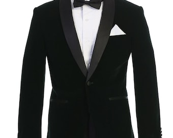 May include: A dark green velvet tuxedo jacket with a black satin lapel and a single button closure. The jacket is paired with black dress pants.