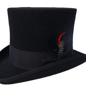 May include: A black top hat with a black band and a small red feather accent.