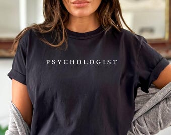May include: A black t-shirt with the word "PSYCHOLOGIST" printed in white on the front.