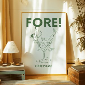 May include: A white poster with a green illustration of a person swinging a golf club into a martini glass. The text "FORE!" is in large green letters at the top of the poster. The text "MORE PLEASE" is at the bottom of the poster.