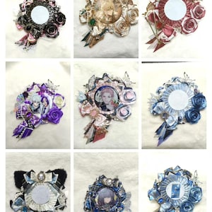 May include: A collection of decorative rosettes with various designs. Each rosette features a central circular element, surrounded by fabric roses, ribbons, and embellishments. Some include character portraits. The color palette includes black, pink, blue, and gold.