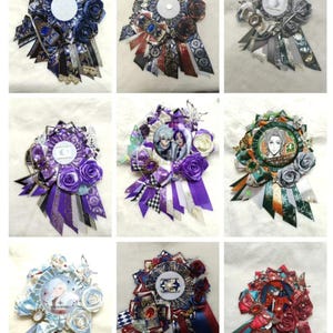 May include: A collection of nine decorative rosette badges. Each badge features a central circular element, surrounded by layered ribbons, fabric, and embellishments. Colors include blue, purple, red, green, and silver, with floral and patterned details.